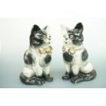A pair of Bo'ness Pottery type hearth cats, with glass eyes, 33 cm