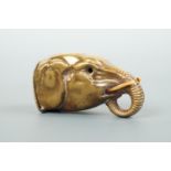 A Victorian novelty lacquered brass vesta in the form of an elephant's head, with ivory tusks and