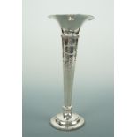 A George V Arts and Crafts influenced silver bud vase, of trumpet form over a stepped circular base,