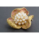 An impressive Italian 18K gold and pearl brooch in the form of a stylized flower head, centrally set