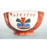 An early 19th Century Scottish creamware bowl commemorating the Battle of Waterloo, hand enamelled