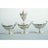 A George V silver condiment set, in a Georgian neo-classical style comprising a pair of glass-
