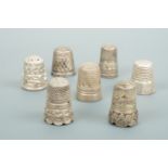 A Charles Horner white metal "Dorcas" thimble, three hallmarked silver thimbles and three others,