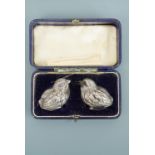 A cased pair of Edwardian silver novelty salt and pepper pots modelled as chicks, Sampson Mordan &