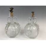 A pair of 19th Century North West European glass decanters, bearing trailed and cut deocration