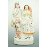 A Victorian Staffordshire-type figurine / mantle ornament, modelled as a lady and gentleman in