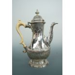 A George III silver baluster coffee pot with ivory handle, having gadrooned decoration, and engraved