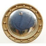 An early 20th Century Regency style gilt-framed convex wall mirror, 45 cm