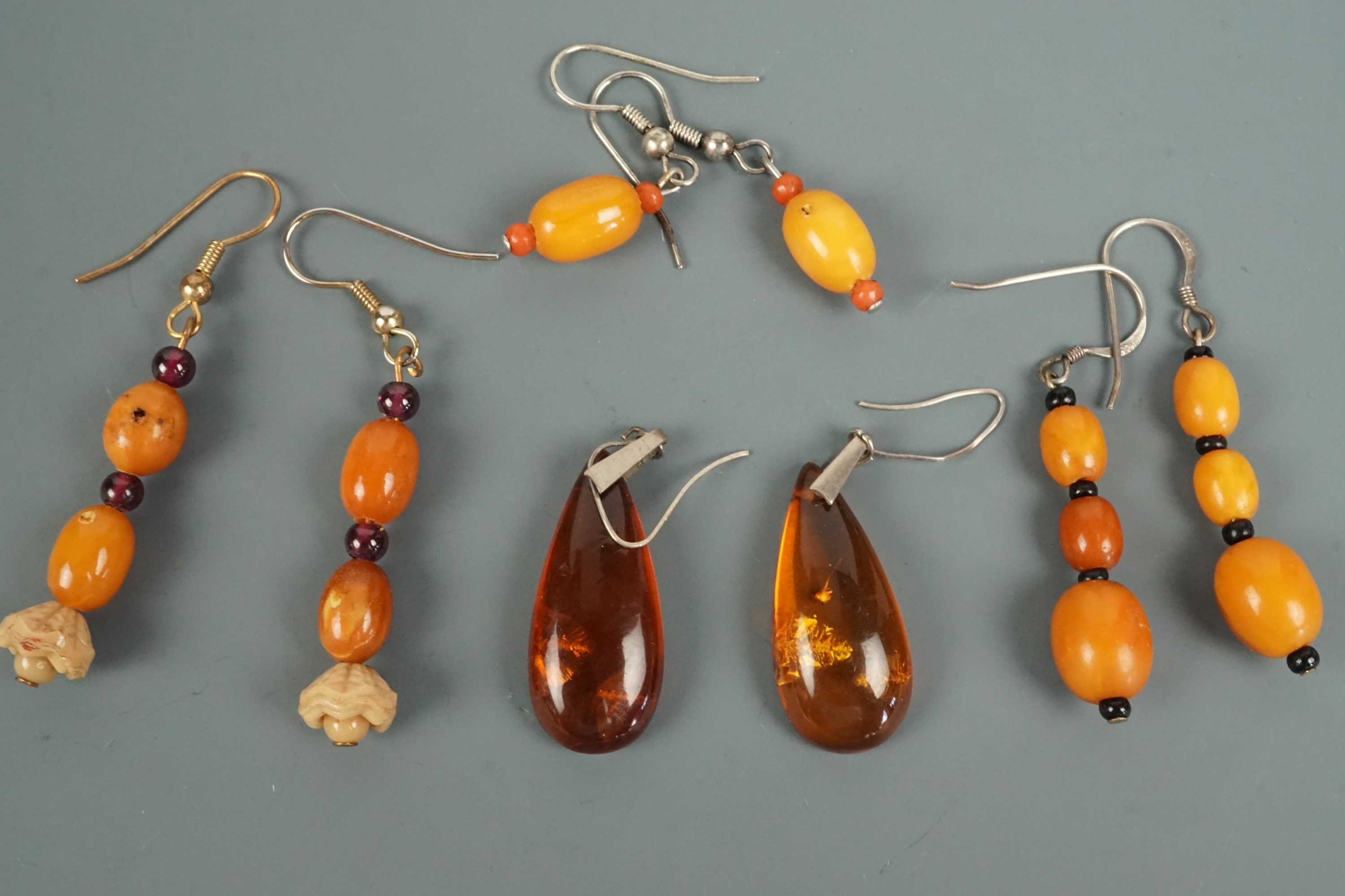 A pair of sun spangled amber teardrop shaped ear pendants together with three pairs of