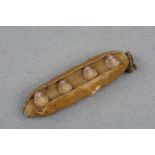A Victorian novelty / Christmas decoration in the form of a pea pod, containing four porcelain