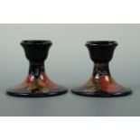 A pair of Moorcroft Pomegranate pattern candle sticks, 8 cm