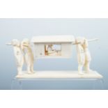 A 19th Century carved ivory model of four bearers carrying a palanquin, 13 cm, (structure loose