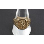 A heavy 9 ct gold signet ring, the bearing the profile portrait of a classical figure in sunken
