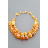 A vintage Latvian amber necklace, with two strands of graded polished beads, on a base metal