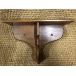 A mahogany bracket shelf