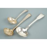 Silver straining and sifting spoons together with a sauce ladle