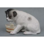 A late 19th Century German bisque comical dog, 6 cm high