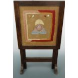 A 1930s oak folding occasional table and fire screen, having a Lancashire Fusiliers embroidered