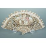A 1920s celluloid hand fan of imitation mother-of-pearl, hand decorated with an 18th Century