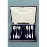 A cased set of six Edwardian silver coffee spoons and sugar tongs, with wriggle-work and bright