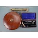 A vintage Treble brand tape measure, spirit level and drawing instruments