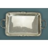 A white metal two handled tray, with scallop shell and bead border, stamped '925', tested as silver,