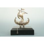 A Greek white metal model of a boat, on an ebonized wooden stand, stamped '925', 14 cm high total