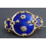 A large Victorian enamelled yellow metal locket brooch, comprising a central oval plaque, basse