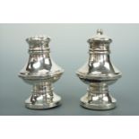 A George V silver salt and pepper pot, of shouldered baluster form with a raised band of decoration,