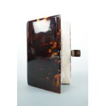 A lady's faux tortoiseshell pocket book with ivory aide memoire, early 20th Century