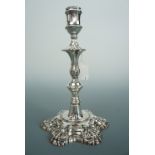 A George III silver candle stick, having an inverted bell form socket, ornately knopped stem, and