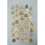 A large quantity of cap badges