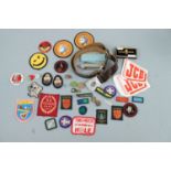 A Girl Guides belt, folding knife and badges together with Scout badges etc.
