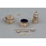 An electroplate cruet set and four spoons