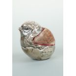 An Edwardian novelty silver pin cushion modelled as a chick hatching from an egg, Sampson Mordan &