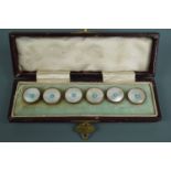 A cased set of six mother-of-pearl waist coat buttons together with a silver heart-shaped pendant