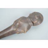 An antique African tribal carved hardwood fertility figure staff finial in the form of a stylized