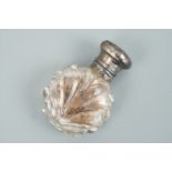 A white metal mounted cut glass scent / smelling salts bottle, having a hinged cap and ground-in