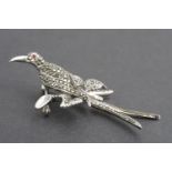 A 1960s silver and marcassite brooch in the form of an exotic bid perched on a branch, 7 cm