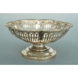 A George V silver footed bon bon dish, with segmented, cusped and reticulated rim, Synyer and