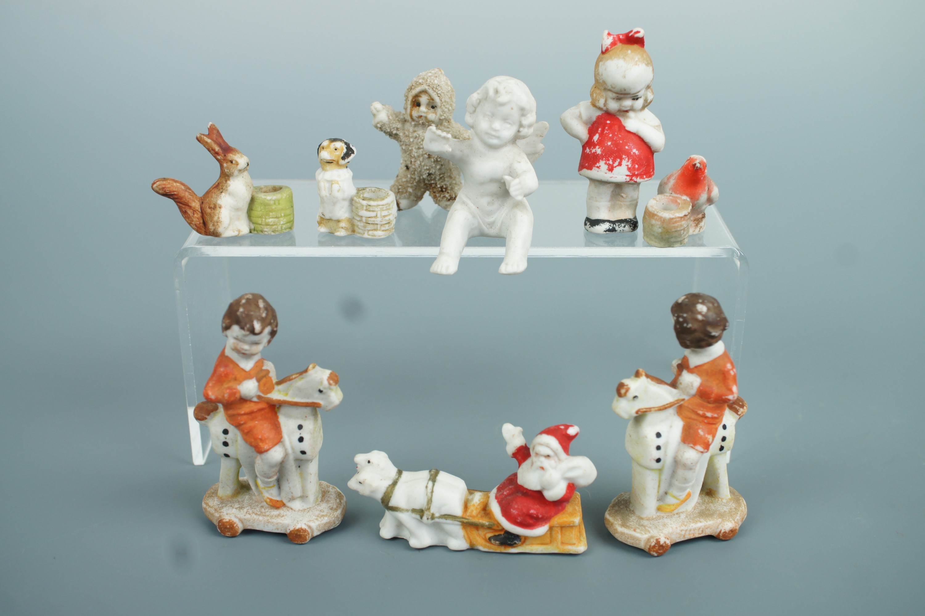 Victorian and later semi-bisque porcelain Christmas and other cake ornaments modelled respectively