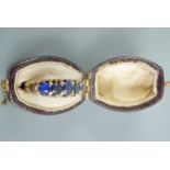 An antique yellow metal and blue stone ring, approx M