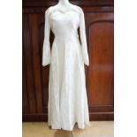 A 1940s lady's damask wedding dress, wax flower headdress and veil, the dress having ruched