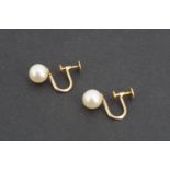 A pair of vintage pearl earrings, having yellow metal screw-backs, the latter stamped K18, pearls