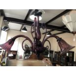 A flamboyant three-branch amethyst glass chandelier, 54 cm