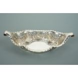 A Victorian silver bon bon basket, of quatrefoil section and elongated boat shape terminating in