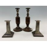 A pair of Walker and Hall electroplate columnar candlesticks, 13 cm high, together with a pair of