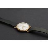 A 1970s Garrard 9 ct gold wrist watch, having a manual movement with circular radially-brushed