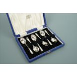 A cased set of six Elizabeth II silver Hanoverian rat tail pattern coffee spoons retailed by