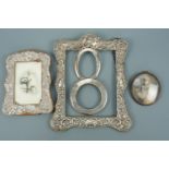Two antique silver photograph frames, the faces of two others and a framed photograph of a young